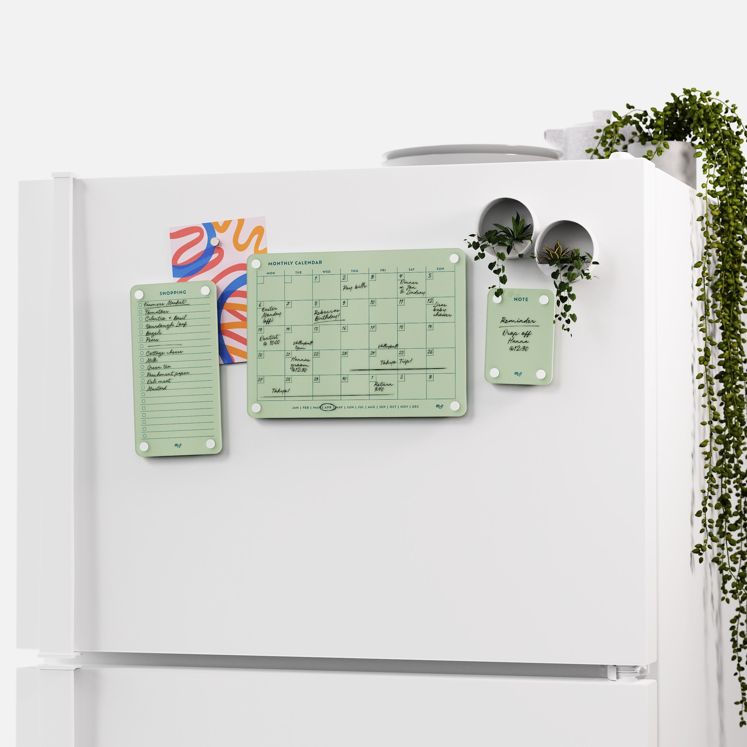 White fridge with the Matcha green shopping list, monthly calendar and note board and two magnetic planters